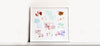 A framed collage of children's drawings scattered around